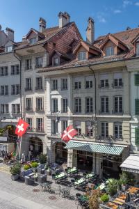 a large building with tables and chairs in front of it at Boutique Hotel Belle Epoque in Bern