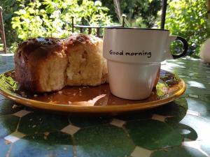 a plate with a loaf of bread and a cup of coffee at Chambre Foret du Mas des Fontaines in Montagnac