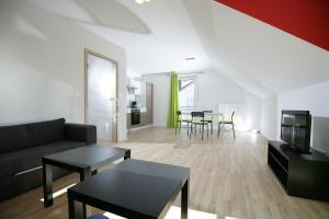 ein Wohnzimmer mit einem Sofa und einem Tisch in der Unterkunft Apartments am Baronenwald in Göppingen