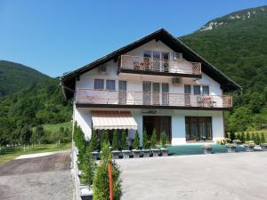 a large white building with a balcony at Apartments Hills in Ćukovi