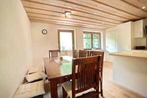 a kitchen and dining room with a table and chairs at Ferienwohnung Stuiben in Blaichach