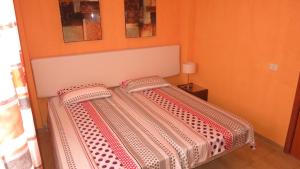 a bed with two pillows on it in a room at Tenerife with impressive pool 315 in Costa Del Silencio +32 photos