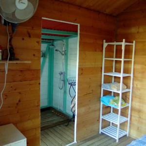a room with a shower and a ladder in a house at CABANE au Soleil by in Saint-François