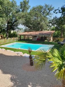 a swimming pool in a yard with a gazebo at Guesthouse Le Pujol in Sainte-Foy-dʼAigrefeuille