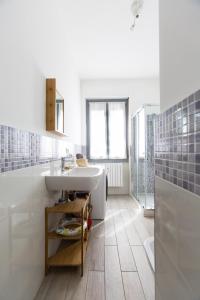 a white bathroom with a sink and a shower at lillaholidays in Milan