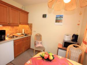 a kitchen with a table with a bowl of fruit on it at Ferienwohnung Wagner in Bad Bellingen