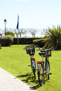 two bikes parked on the grass in a park at Le Castel Marie Louise in La Baule