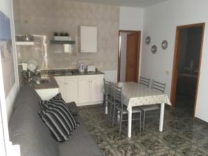 a kitchen with a table and chairs in a room at Orzola mar y relax in Órzola