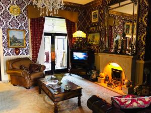 a living room with a couch and a fireplace at Castle Lodge Guest House 86-88 Sheil Rd L6 3AF in Liverpool