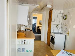 a kitchen with a counter and a stove top oven at Haus Boy Jensen Wohnung Dünenblick in Wenningstedt