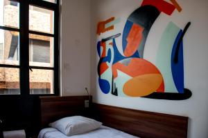 Postel nebo postele na pokoji v ubytování Hôtel le Pastel