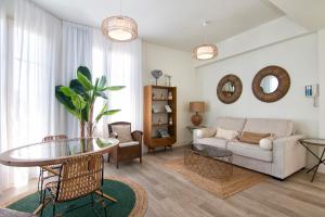 a living room with a couch and a table at Granada Luxury Apartments by Apolo Homes in Granada