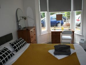 A bed or beds in a room at Golden Triangle Rooms