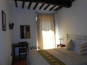 a bedroom with a large bed and a window at Civita B&B in Bagnoregio