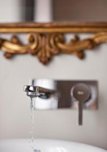 a bathroom sink with water running from a faucet at Il Genovino in Genoa