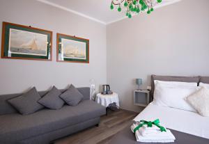 a living room with a bed and a couch at Il Genovino in Genoa