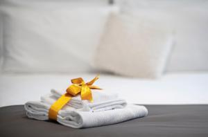 a pair of towels with a yellow bow on them at Il Genovino in Genoa