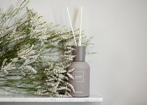 a bottle of liquid soap next to a bouquet of flowers at Il Genovino in Genoa