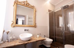 a bathroom with a sink and a shower and a mirror at Il Genovino in Genoa