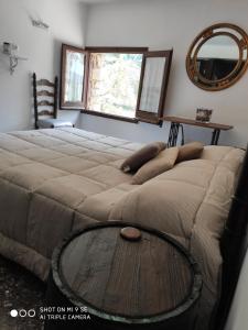 a bedroom with a bed with a table on it at Hostal Moliné in Bruguera