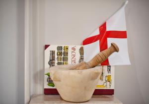 a vase sitting on top of a table with a book at Il Genovino in Genoa
