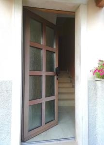 a door to a house with a staircase at CASETTA DI FEM in Sabbionara