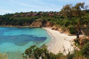 a beach on a hill with blue water and trees at Dimora Simius in Villasimius