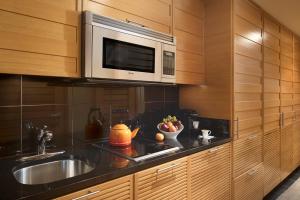 a kitchen with a sink and a microwave at Viceroy Snowmass in Snowmass Village