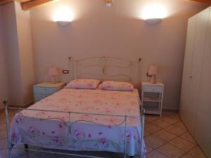 1 dormitorio con 1 cama y 2 mesitas de noche en Il carpino bianco bilocale, en Puegnago sul Garda