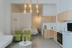 a kitchen and living room with a couch and a table at Prima Gardens City Studios in Larnaka