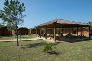 a pavilion with picnic tables in a park at Alojamiento Rural Coto de la Isleta in El Puerto de Santa María