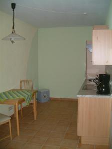 a kitchen with a table and a counter top at Ferienwohnung Hermann in Sankt Aldegund +4 photos