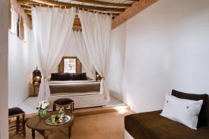 Tempat tidur dalam kamar di Riad Vert