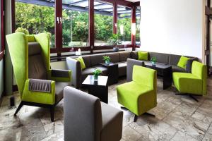 a living room filled with couches and chairs at Hotel Rieth in Böblingen
