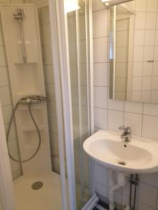 a bathroom with a sink and a shower at Søndre Berg gate 20 Apartement in Vardø