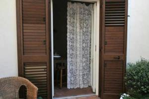 a door leading to a window with a curtain at B&B del Giglio in Cefalù