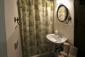 a bathroom with a sink and a shower curtain at B&B del Giglio in Cefalù