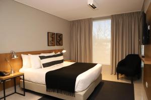 a hotel room with a bed and a window at Agua del Corral Hotel & Spa in Mendoza +50 photos