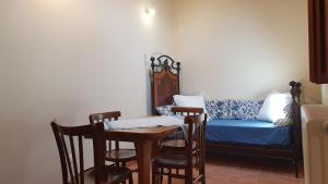 a living room with a couch and a table and chairs at La Torretta Medicea in Santo Stefano di Sessanio