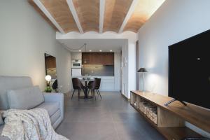 a living room with a couch and a tv at Abu Said by CASALEA in Morella