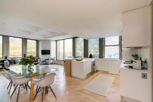 a kitchen and living room with a table and chairs at #1803 Cartwright - Simply Spectacular in Cape Town