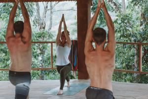 a group of men and a woman doing yoga at Ch'i Bocól Community Hostel in Lanquín