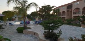 a resort with a swimming pool and a hotel at Daniel Hotel in Kalamaki