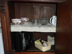 a cupboard with bowls and dishes on a shelf at L'EPICERIE in Pau