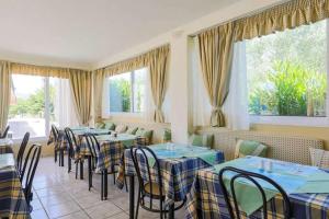 a row of tables and chairs in a restaurant at Daniel Hotel in Kalamaki