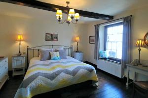 a bedroom with a bed and a window at Kings Head Holt in Holt