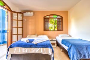 En eller flere senge i et værelse på Pousada Recanto Barra da Tijuca + 29 billeder