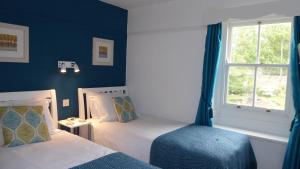 Katil atau katil-katil dalam bilik di Rosegarth Guest House