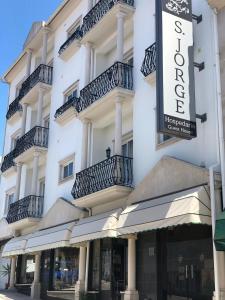 a large white building with balconies on it at Hospedaria S. Jorge in Fátima