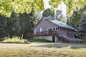 a large house with a porch and a deck at Last Wilderness in Katinka Village